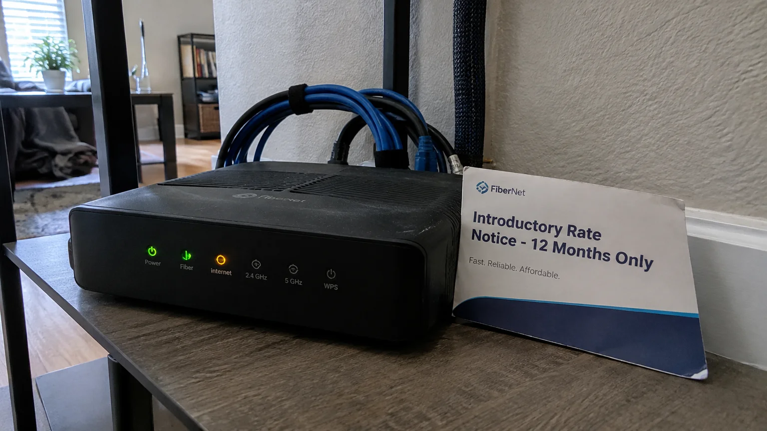 FiberNet Wi-Fi router on a shelf next to a card reading Introductory Rate Notice - 12 Months Only.